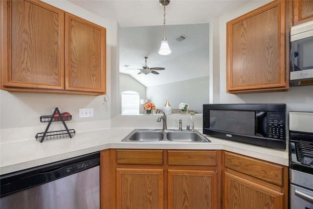 kitchen with lofted ceiling, ceiling fan, decorative light fixtures, sink, and appliances with stainless steel finishes