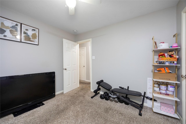 exercise room with light carpet and ceiling fan