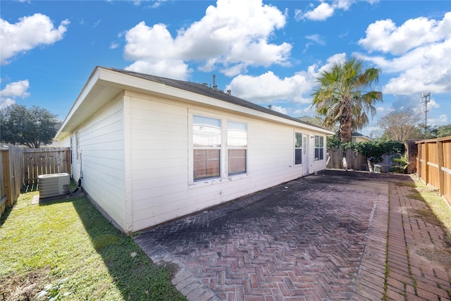 view of property exterior featuring cooling unit and a patio