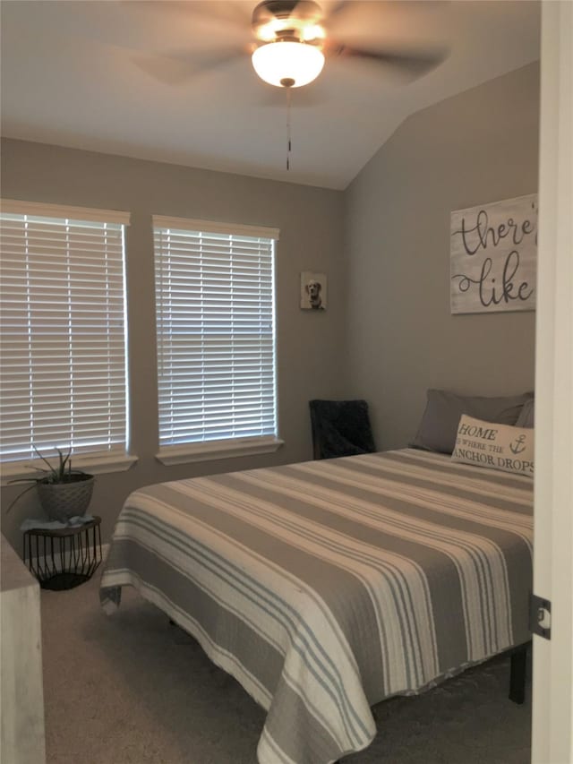 carpeted bedroom with vaulted ceiling and ceiling fan