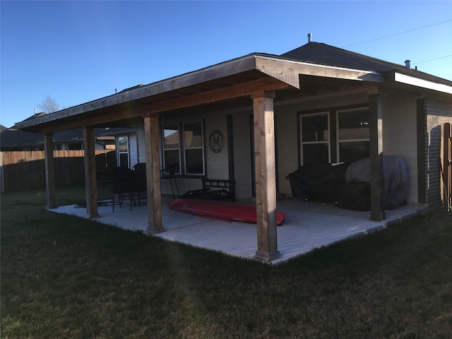 back of house featuring a yard and a patio area