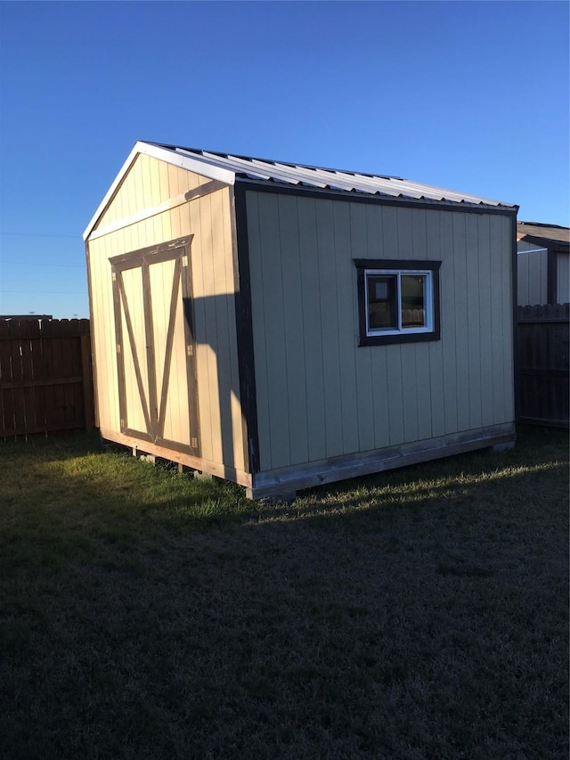 view of outbuilding featuring a yard