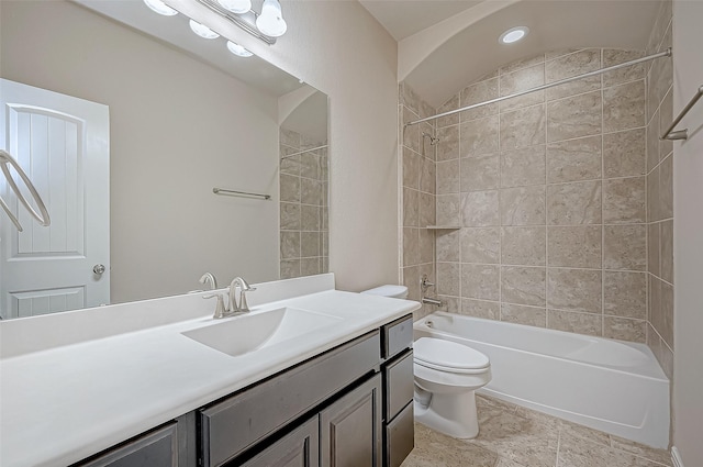 full bathroom with toilet, vanity, and tiled shower / bath combo