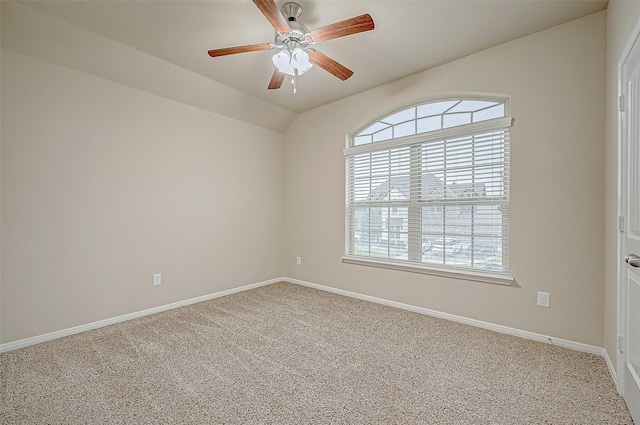 carpeted spare room with ceiling fan and lofted ceiling