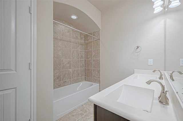 bathroom with tiled shower / bath combo, tile patterned floors, and vanity