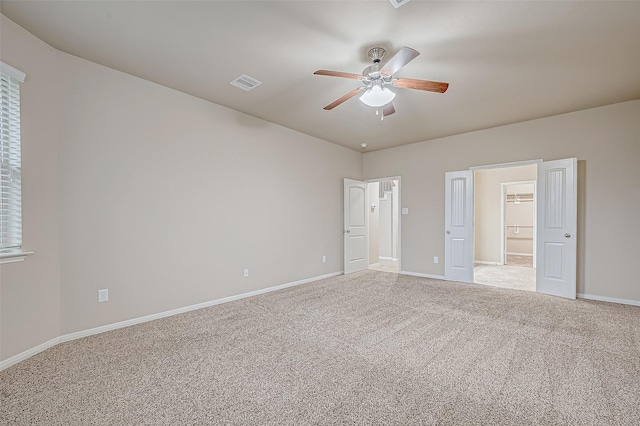 unfurnished bedroom featuring ceiling fan and light colored carpet