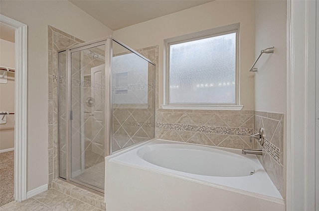 bathroom featuring tile patterned floors and independent shower and bath