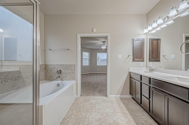 bathroom featuring a washtub, ceiling fan, and vanity