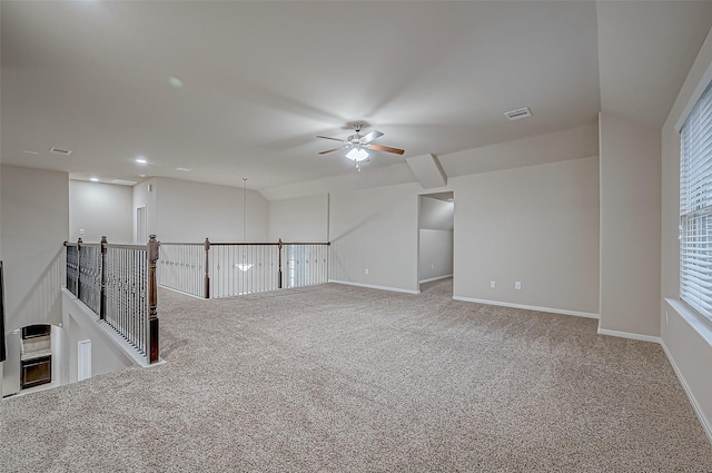 carpeted spare room with ceiling fan and lofted ceiling