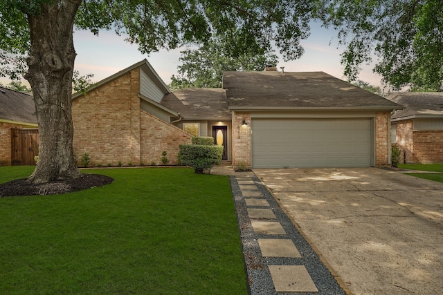 view of front of house with a yard and a garage