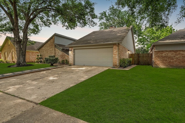 view of front of home featuring a yard and a garage