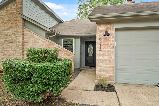 view of exterior entry featuring a garage