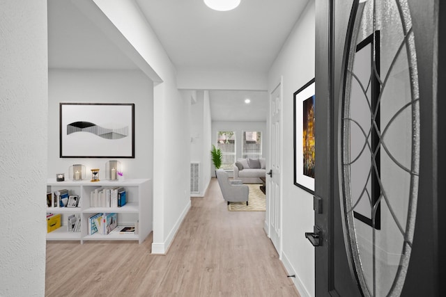 corridor with light hardwood / wood-style flooring