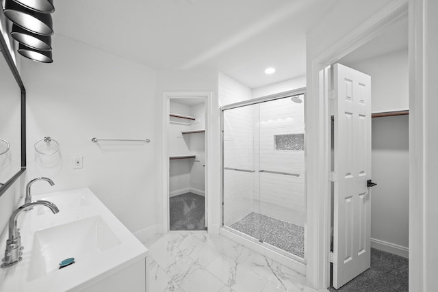 bathroom featuring vanity and a shower with shower door