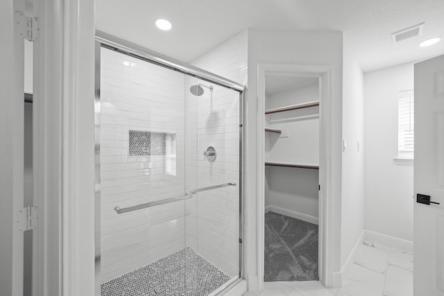 bathroom featuring a shower with shower door