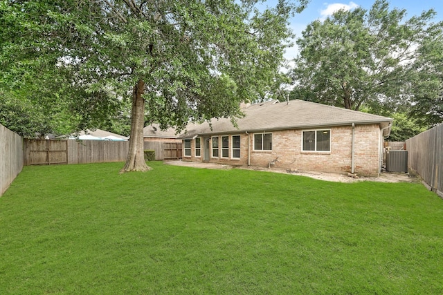 back of house featuring cooling unit and a yard