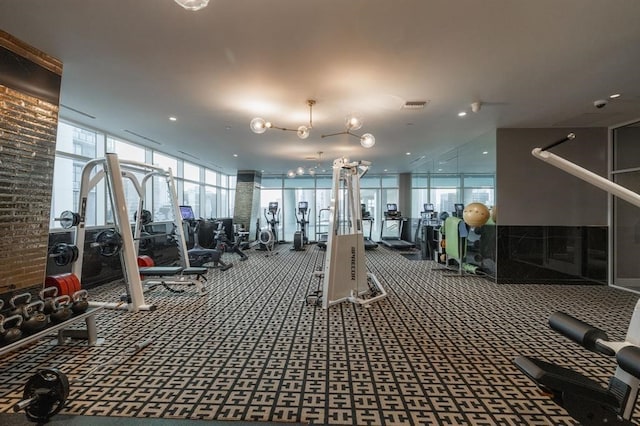 workout area featuring floor to ceiling windows and carpet flooring