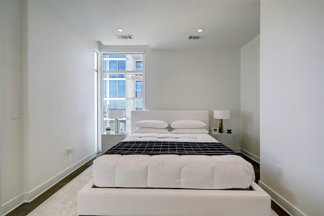 bedroom with dark wood-type flooring