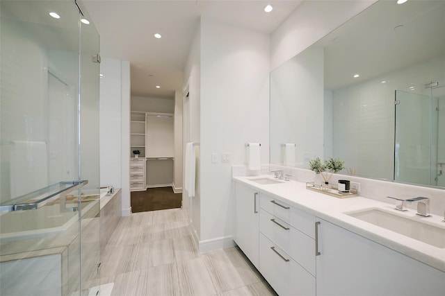 bathroom with tile patterned floors, vanity, and shower with separate bathtub