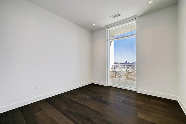 unfurnished room featuring dark wood-type flooring