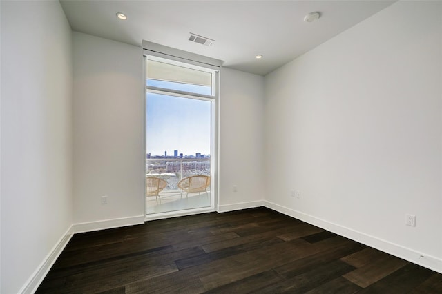 spare room with dark hardwood / wood-style floors