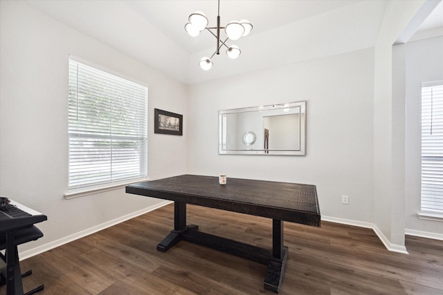 office space with dark wood-type flooring and a chandelier