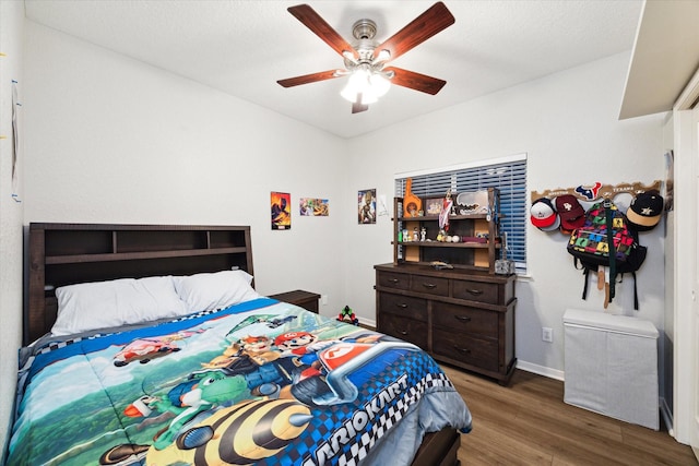 bedroom featuring ceiling fan and dark wood-type flooring