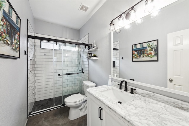 bathroom with toilet, a shower with shower door, and vanity