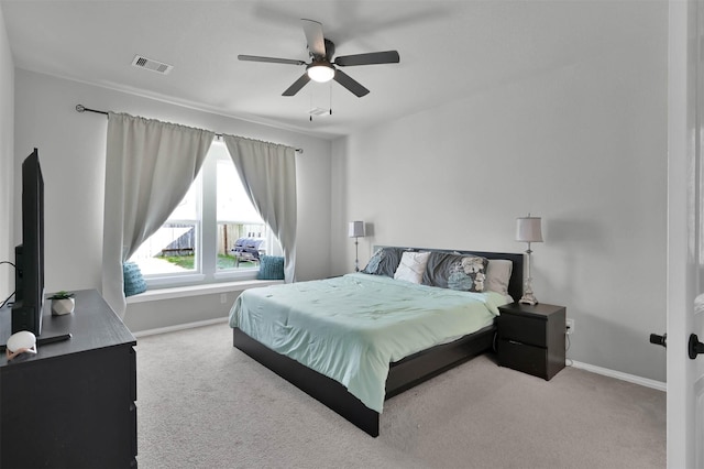 bedroom featuring ceiling fan and light carpet