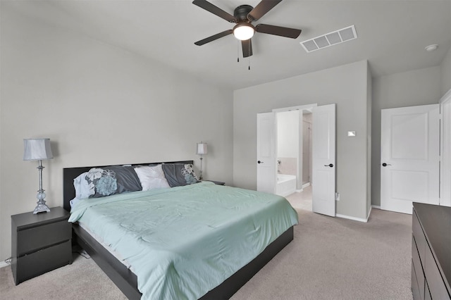 carpeted bedroom with ceiling fan and ensuite bathroom