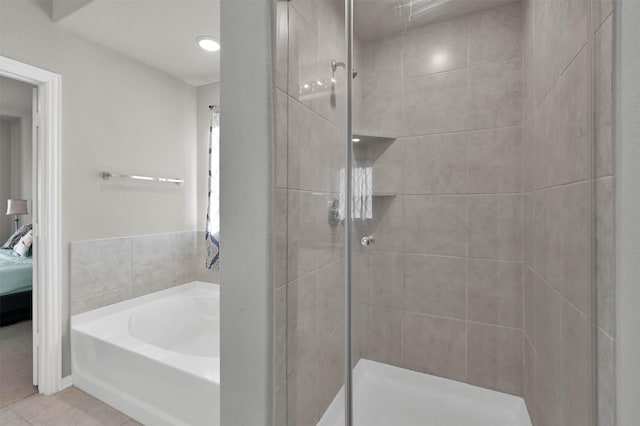 bathroom with tile patterned floors and separate shower and tub