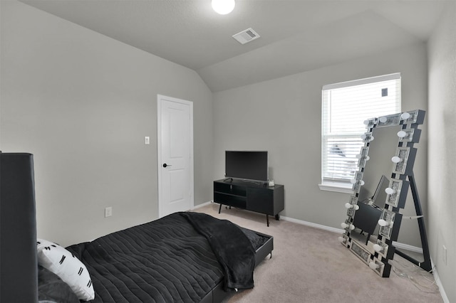 carpeted bedroom with lofted ceiling