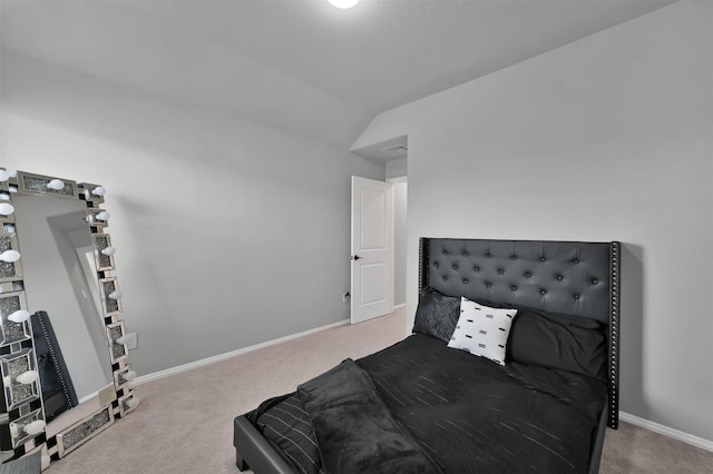 carpeted bedroom featuring lofted ceiling