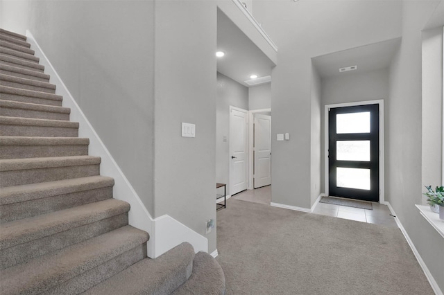 view of carpeted foyer entrance