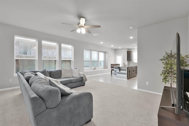 carpeted living room with ceiling fan