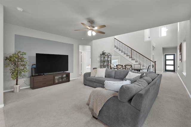 carpeted living room featuring ceiling fan