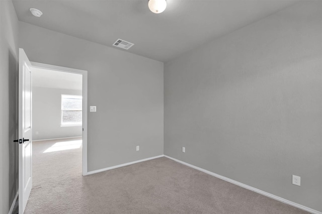 empty room featuring light colored carpet