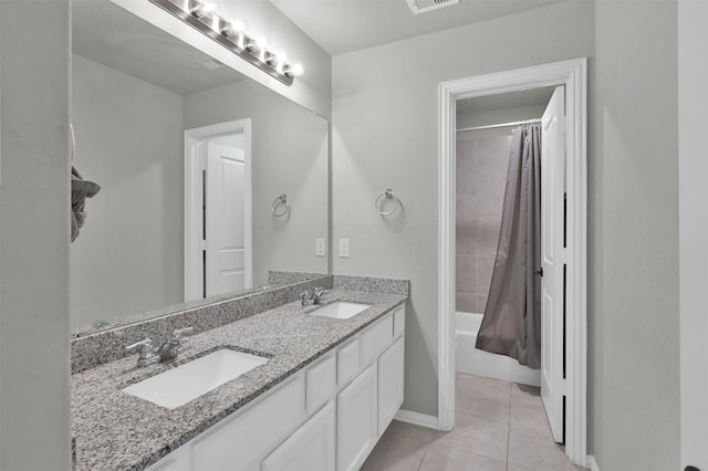 bathroom with shower / bath combo with shower curtain, tile patterned floors, and vanity