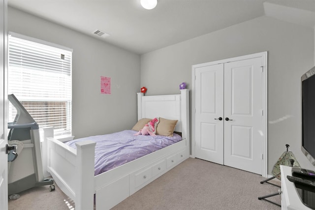 carpeted bedroom featuring a closet