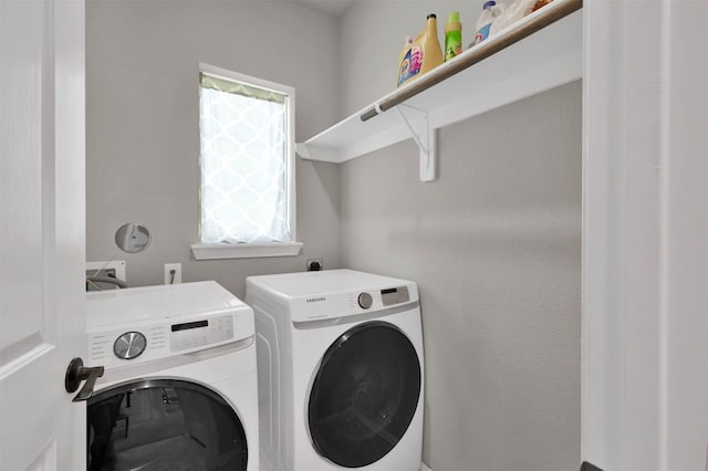 laundry room with washer and dryer and a healthy amount of sunlight