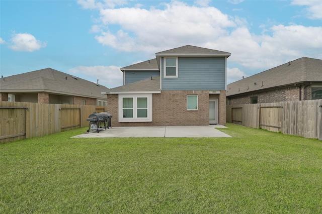 back of house featuring a patio area and a yard