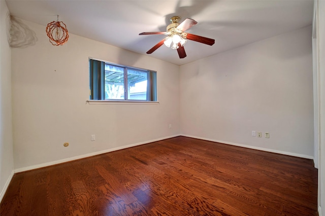 unfurnished room featuring ceiling fan and dark hardwood / wood-style flooring