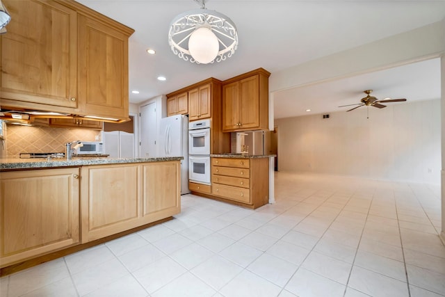 kitchen featuring pendant lighting, white appliances, ceiling fan, and light stone countertops