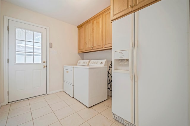 laundry room with light tile patterned floors, washing machine and dryer, and cabinets