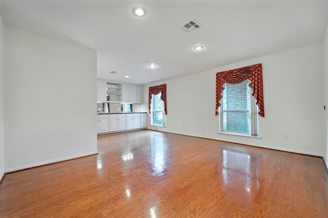 unfurnished living room featuring light wood-type flooring