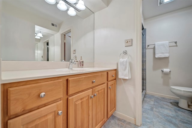 bathroom featuring vanity, an enclosed shower, and toilet