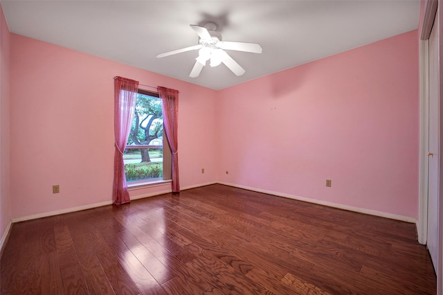 empty room featuring ceiling fan and dark hardwood / wood-style flooring