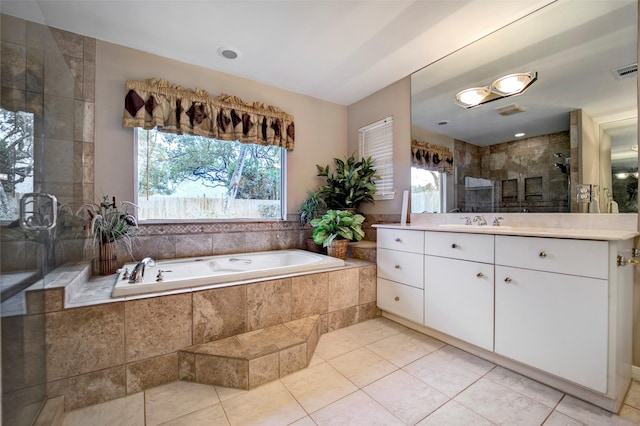 bathroom featuring vanity, shower with separate bathtub, and tile patterned flooring