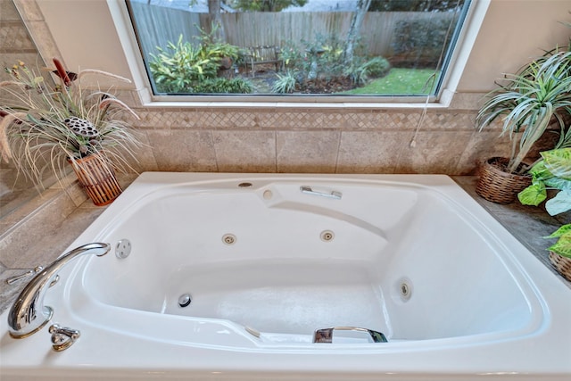 bathroom with a relaxing tiled tub