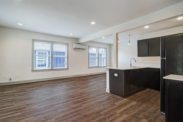 kitchen with hanging light fixtures, kitchen peninsula, dark wood-type flooring, a wall mounted air conditioner, and sink